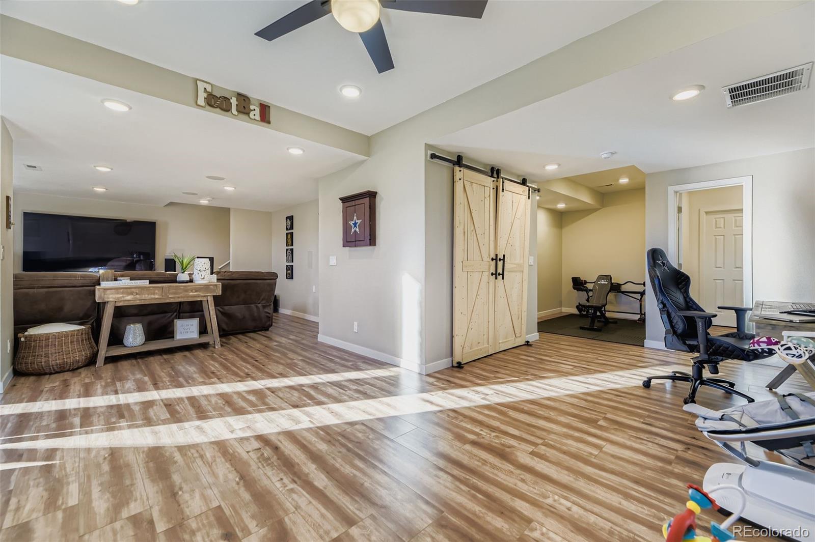 1126 Williams Loop Elizabeth, CO 80107 - Photo 32 of 50 a view of a room with gym equipment and wooden floor