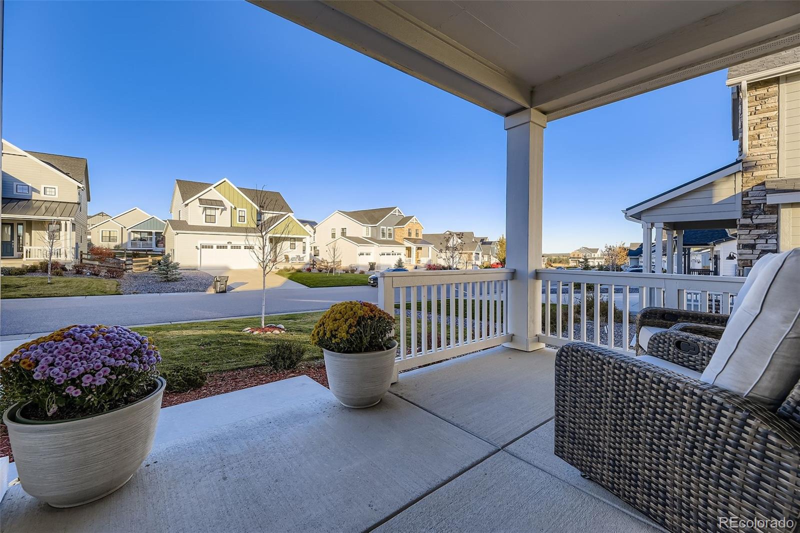 1126 Williams Loop Elizabeth, CO 80107 - Photo 5 of 50 a view of a balcony with two chairs and a potted plant