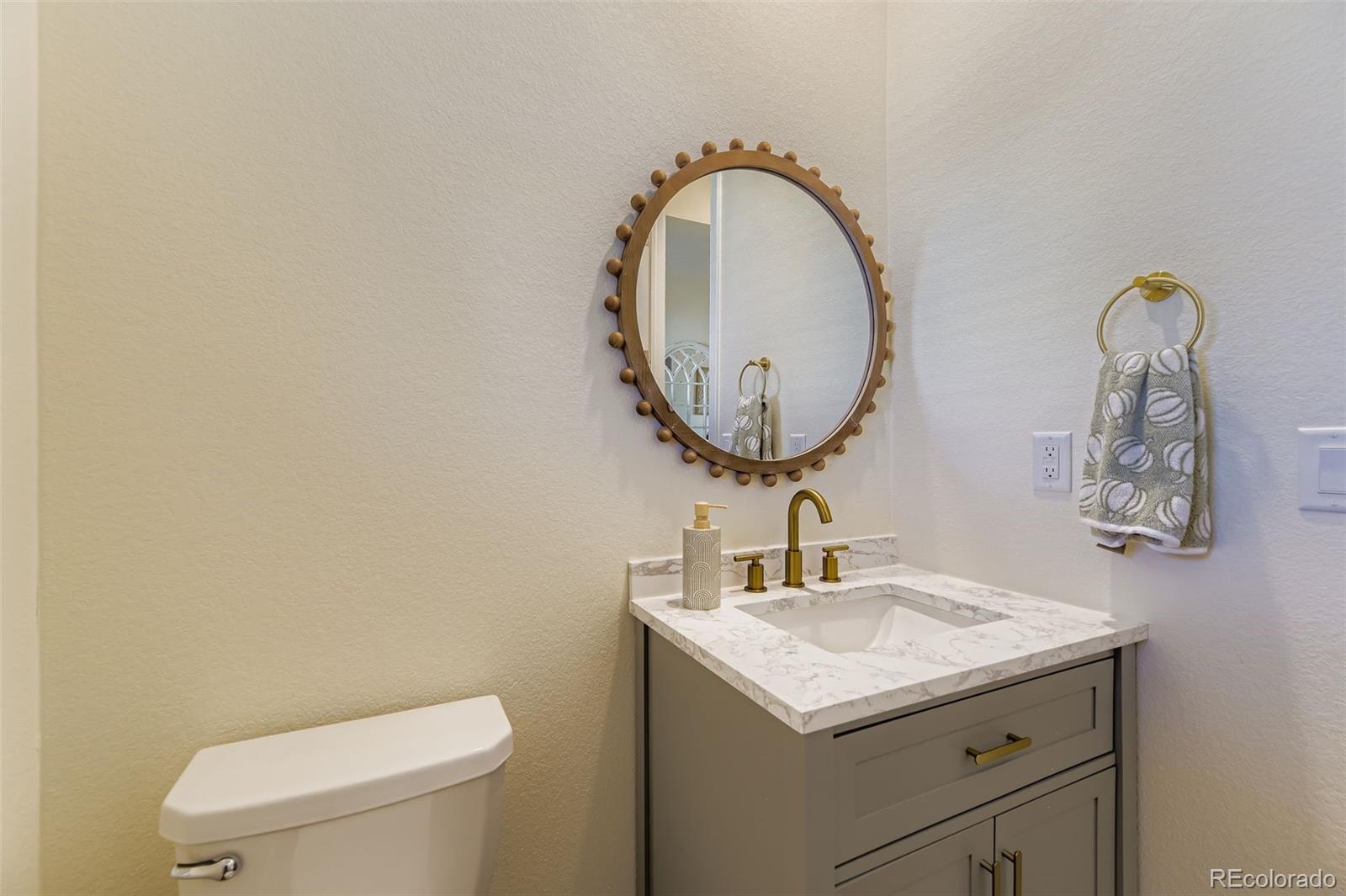 1126 Williams Loop Elizabeth, CO 80107 - Photo 8 of 50 a bathroom with a toilet sink and mirror