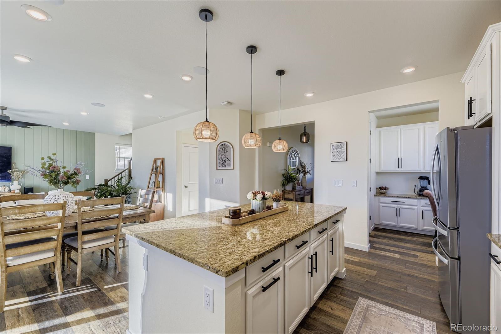 1126 Williams Loop Elizabeth, CO 80107 - Photo 10 of 50 a kitchen with granite countertop a sink stove and refrigerator