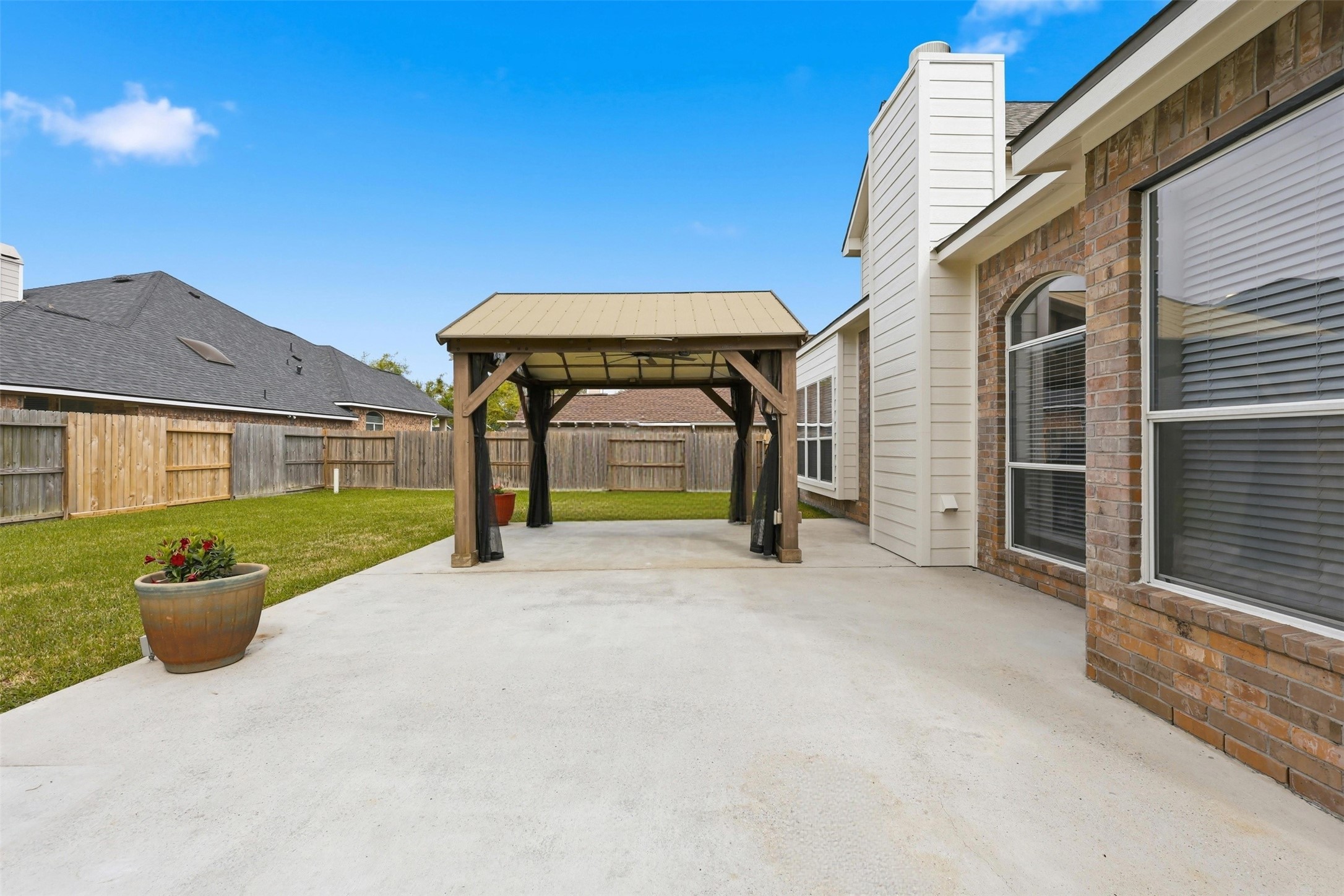 17406 North Riata Lake Cypress, TX 77433 - Photo 24 of 33 Expansive patio and pergola area with plenty of room for dining, gathering, or quiet evenings outside.