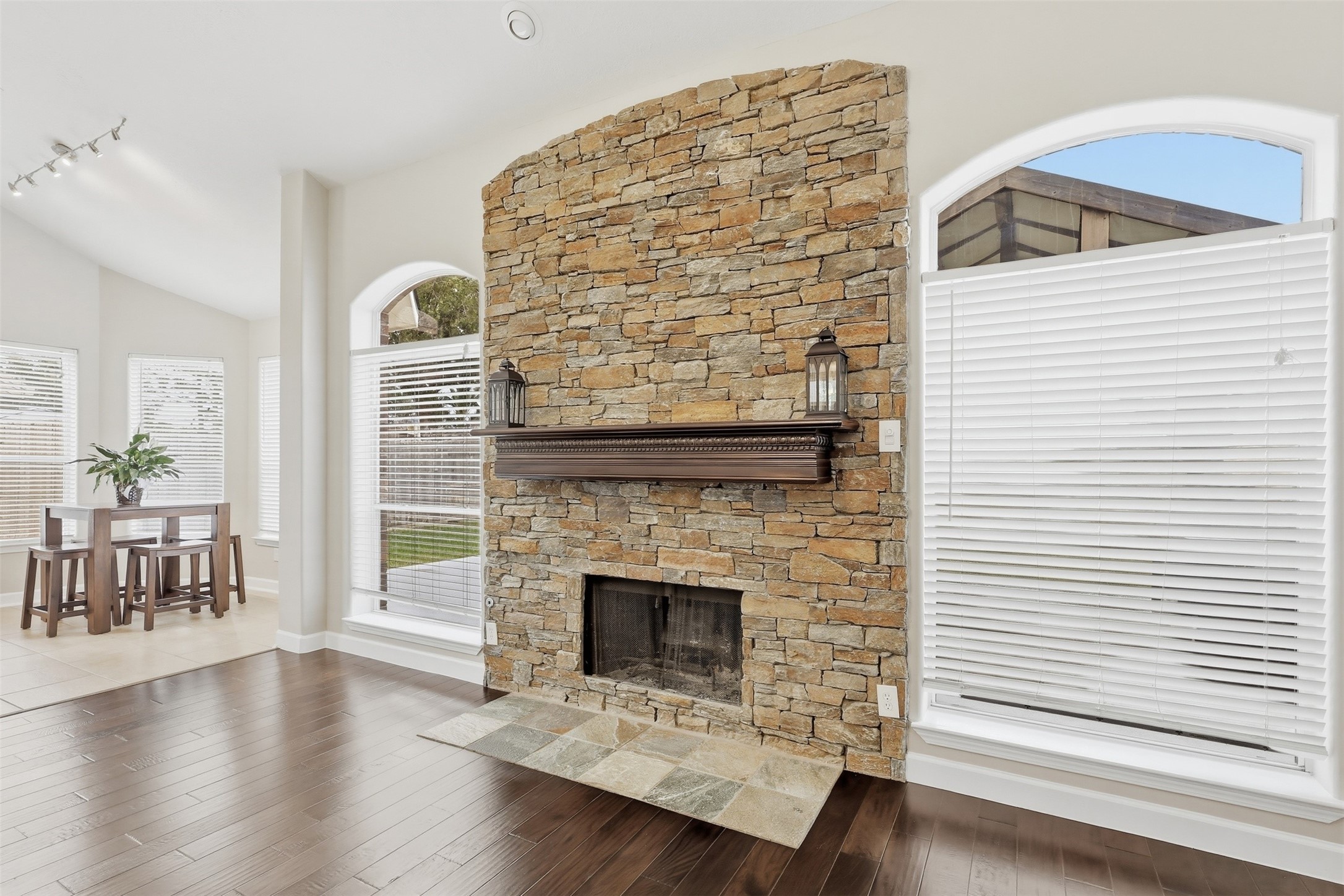 17406 North Riata Lake Cypress, TX 77433 - Photo 10 of 33 Striking floor-to-ceiling stone fireplace creating a warm focal point in the main living area.