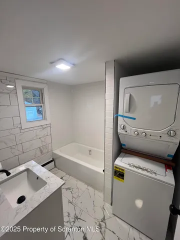a bathroom with a sink toilet and tub