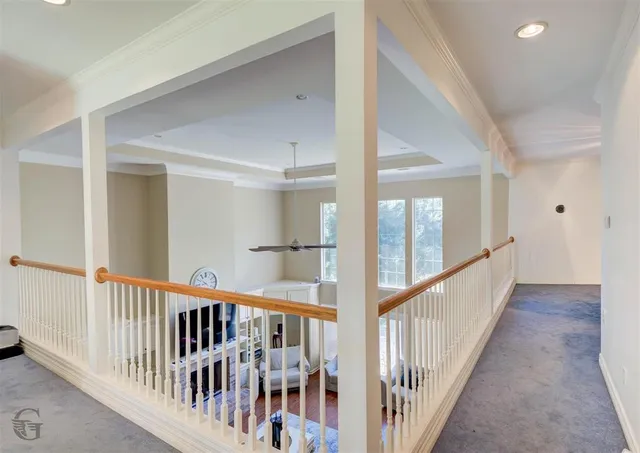 a view of a hallway with wooden floor and entryway