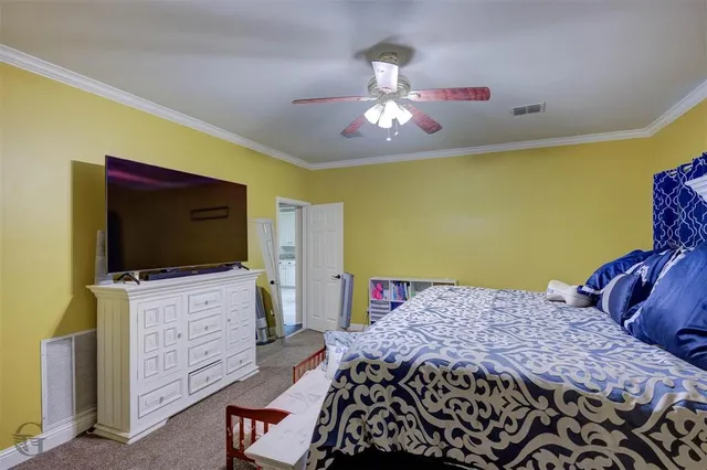 a bedroom with a bed and flat screen tv