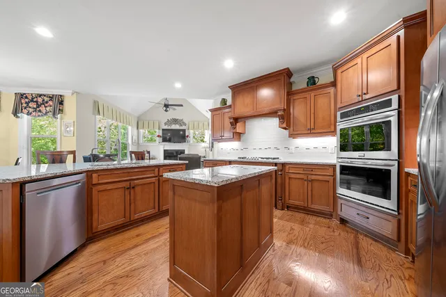 a view of a hallway with wooden floor and stairs