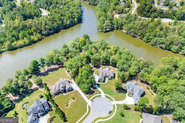an aerial view of a house with a lake view
