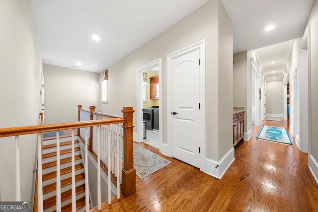 an aerial view of lake residential house with swimming pool and outdoor seating