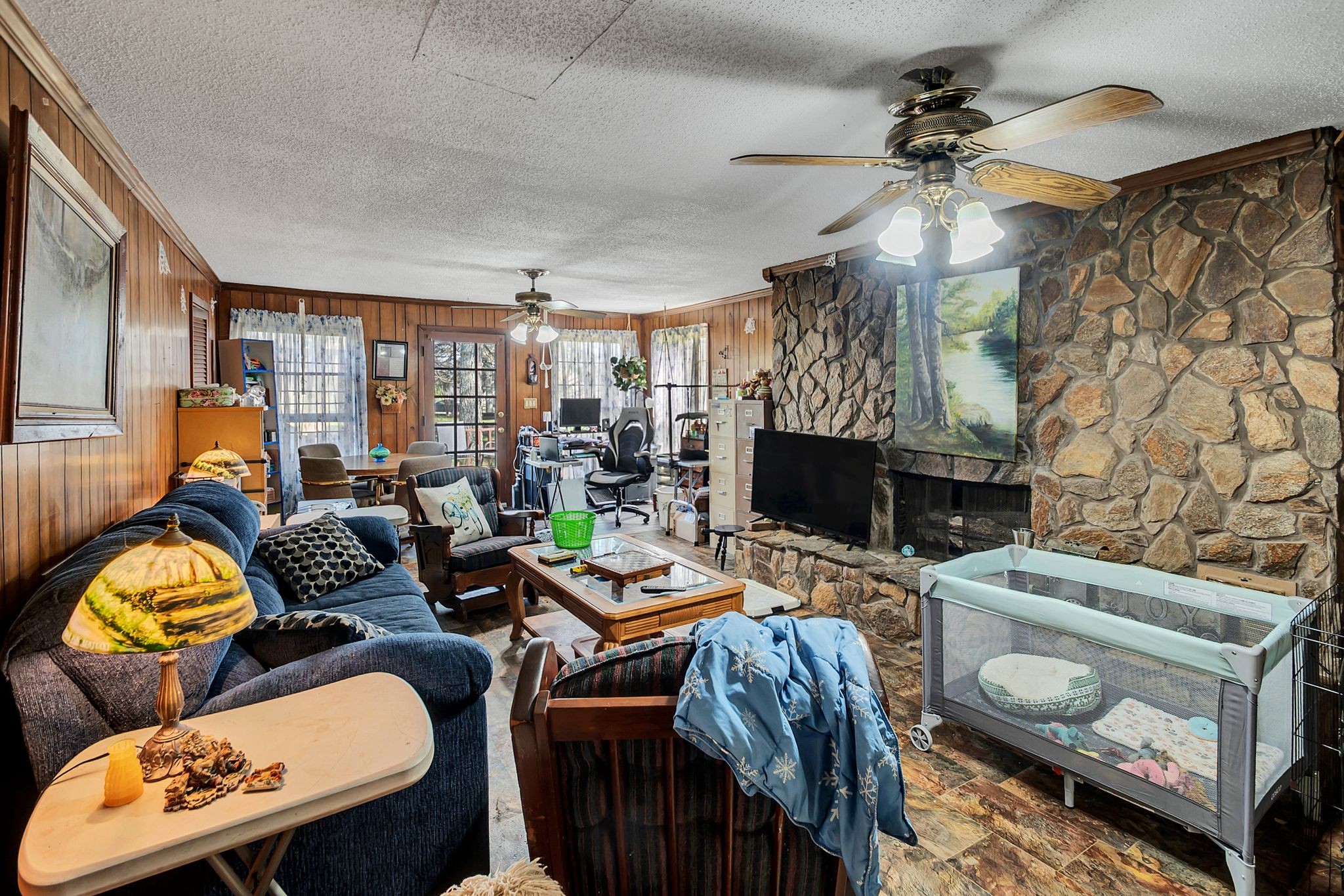 26454 Austin Whitt Road Ardmore, TN 38449 - Photo 18 of 49 a living room with furniture a fireplace and a flat screen tv