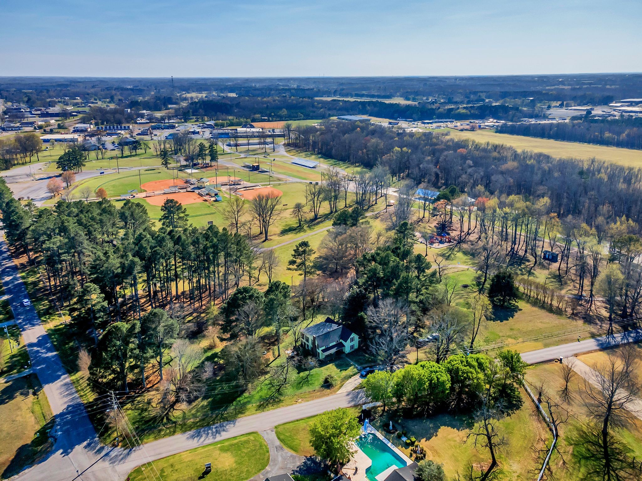 26454 Austin Whitt Road Ardmore, TN 38449 - Photo 2 of 49 an aerial view of residential houses with outdoor space and swimming pool