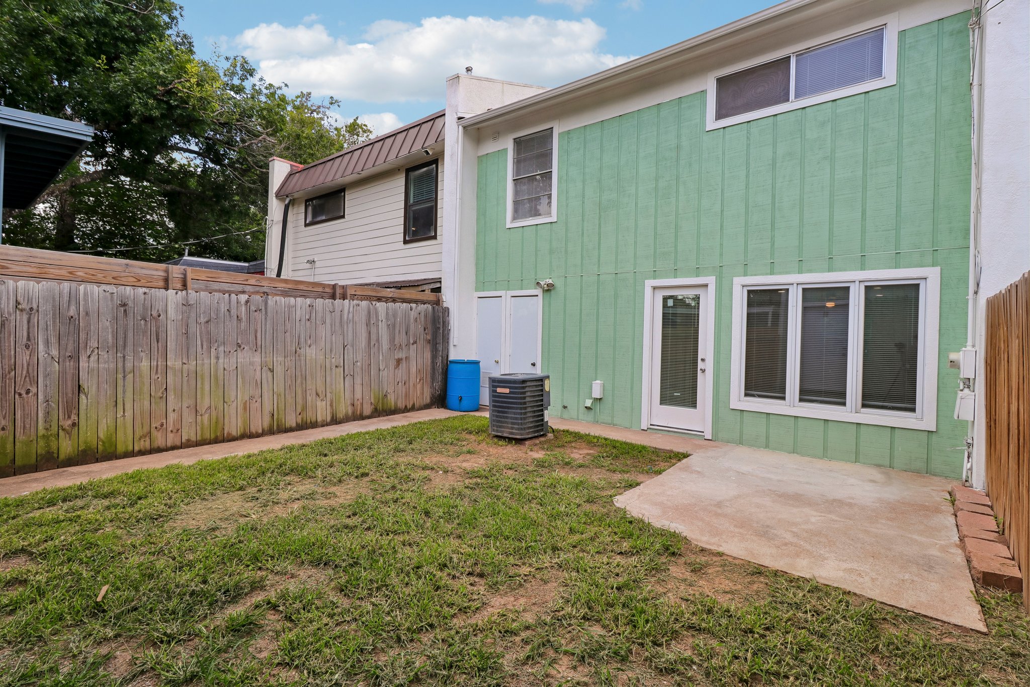 5809 Coventry Lane Austin, TX 78723 - Photo 24 of 35 A quaint backyard with a concrete patio offers a private outdoor retreat.