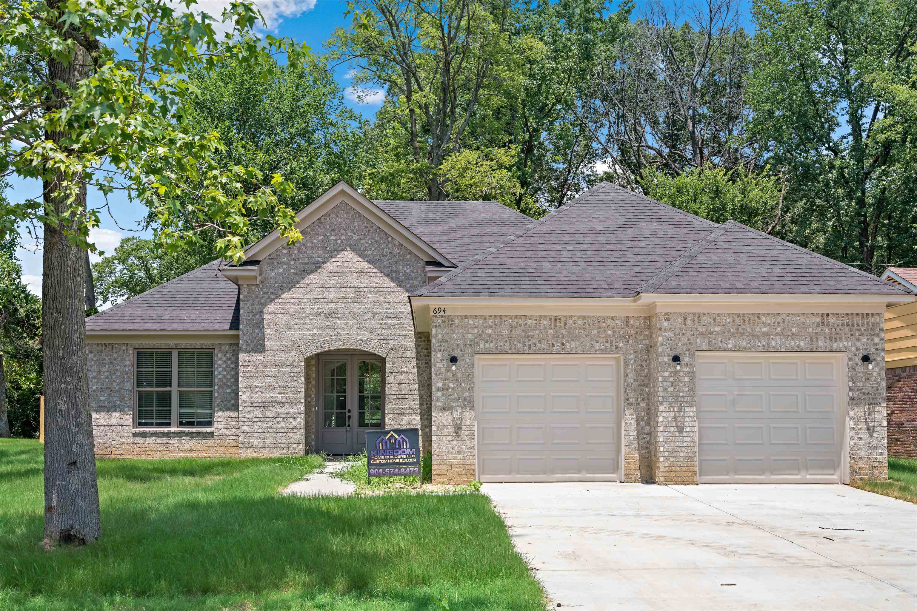 View of front of home featuring a garage and a front yard