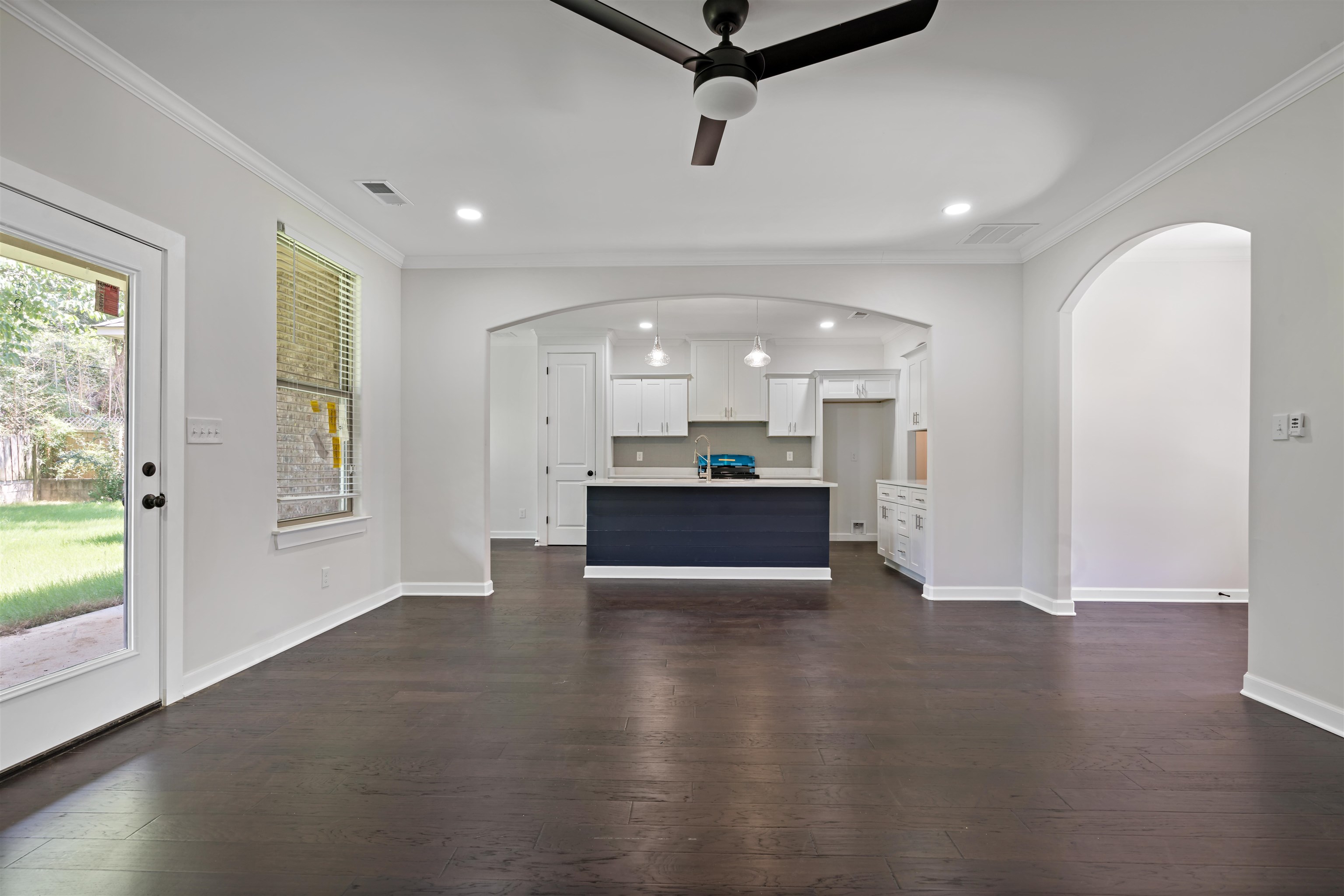694 Brownlee Road Memphis, TN 38116 - Photo 3 of 15 Unfurnished living room with dark hardwood / wood-style floors, crown molding, and ceiling fan