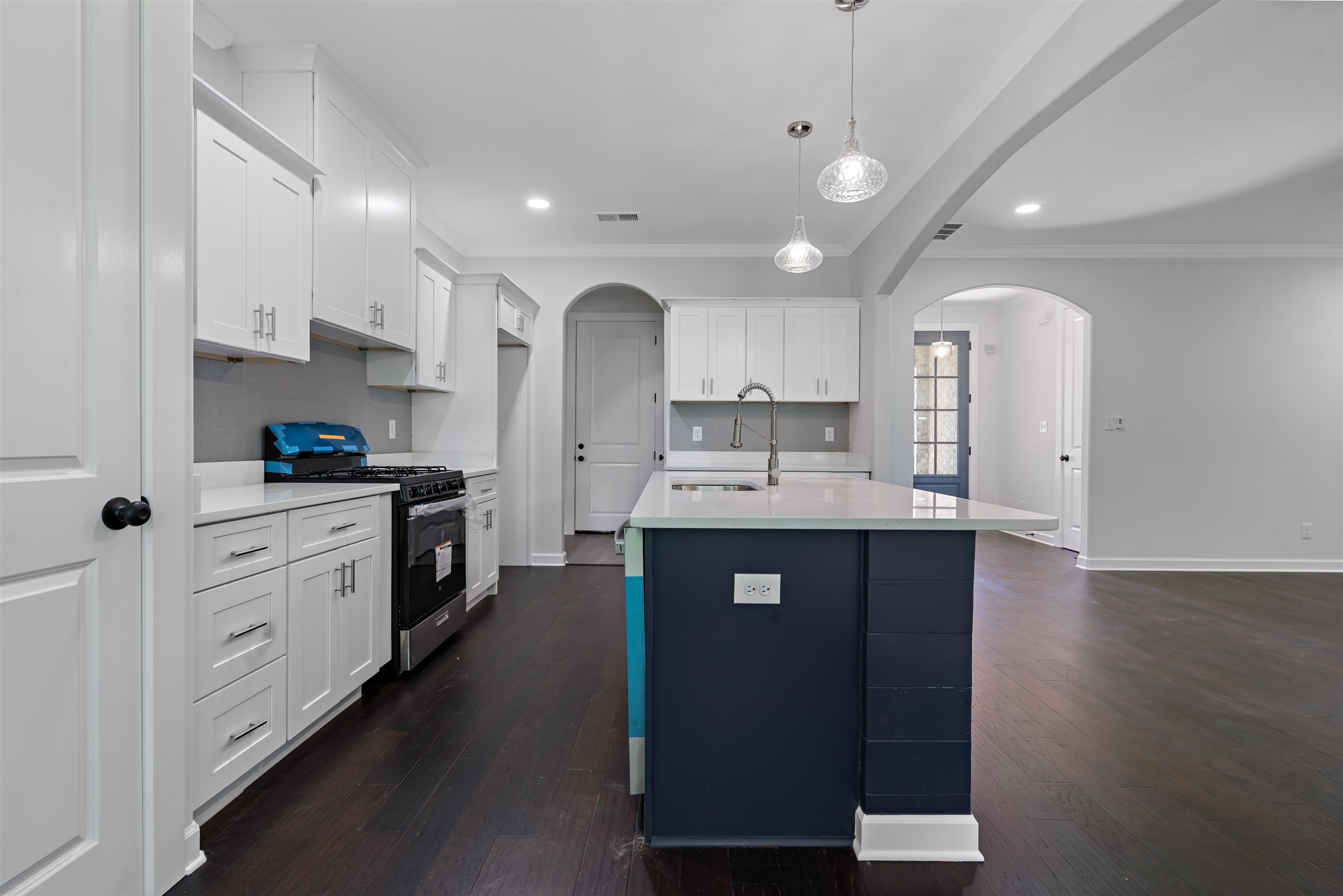 694 Brownlee Road Memphis, TN 38116 - Photo 5 of 15 Kitchen with gas range, white cabinetry, sink, and dark wood-type flooring