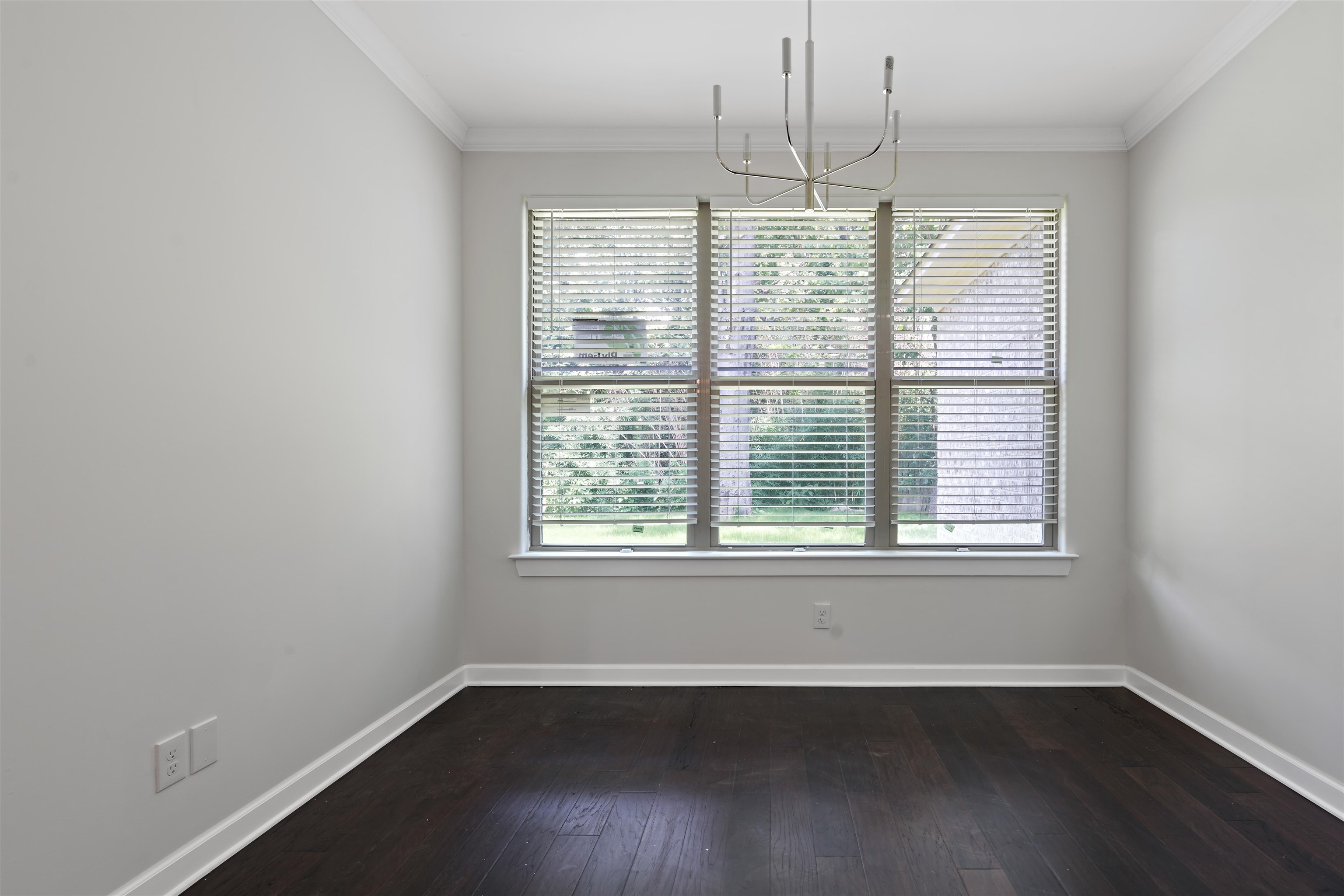 694 Brownlee Road Memphis, TN 38116 - Photo 6 of 15 Empty room featuring an inviting chandelier, crown molding, and hardwood / wood-style flooring