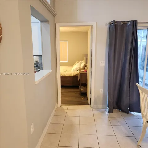 a bed sitting in a bedroom next to a window with wooden floor