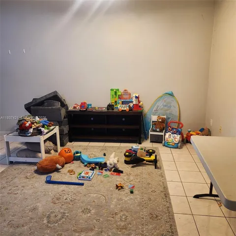 a kitchen with kitchen island sink stove top oven and cabinets