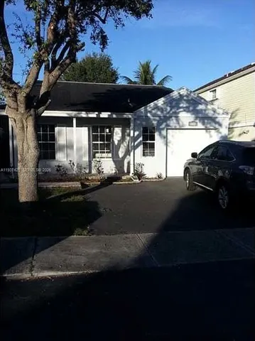 a view of a street with cars parked on the road
