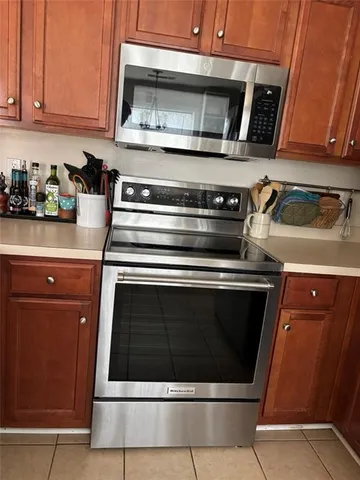 a stove top oven sitting inside of a kitchen