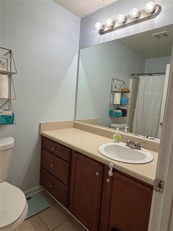 142 Melody Lane Northwest Rome, GA 30165 - Photo 27 of 45 a bathroom with a sink a toilet a mirror and vanity