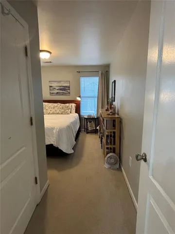 a bedroom with a bed and a mirror
