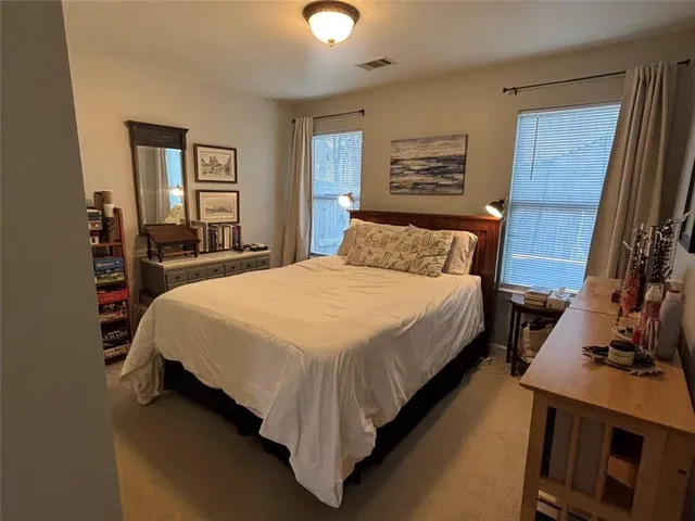 a bedroom with a bed and a painting on the wall