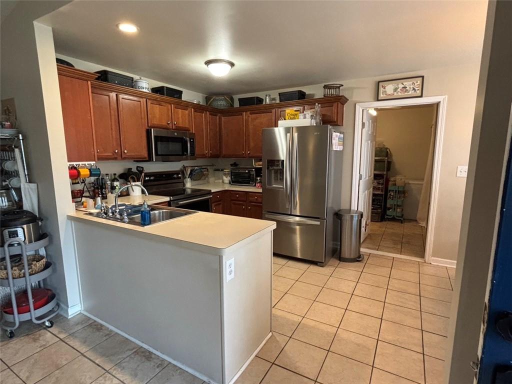 142 Melody Lane Northwest Rome, GA 30165 - Photo 10 of 45 a kitchen with stainless steel appliances a refrigerator sink and cabinets