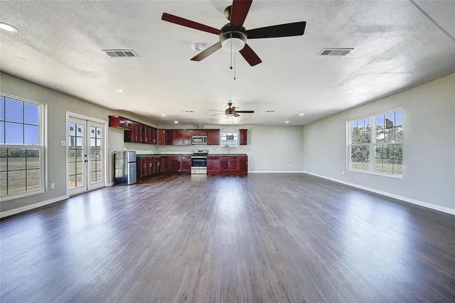 a kitchen with stainless steel appliances granite countertop a stove and a wooden floors