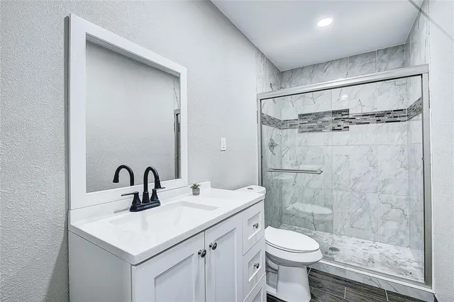 a bathroom with a sink toilet and shower