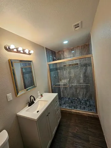 a bathroom with a sink a toilet and a mirror