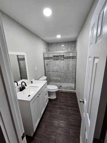 a bathroom with a sink a toilet and a shower
