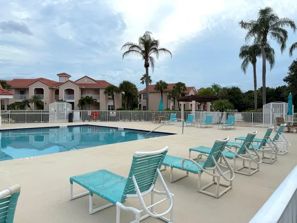 a view of a house with swimming pool and sitting area