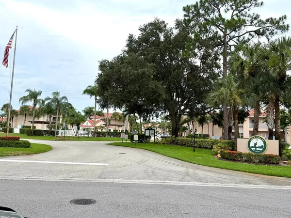 a city view with tall trees and a yard
