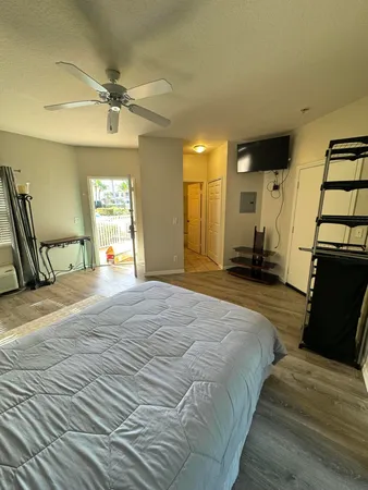 a spacious bedroom with a bed and a chandelier