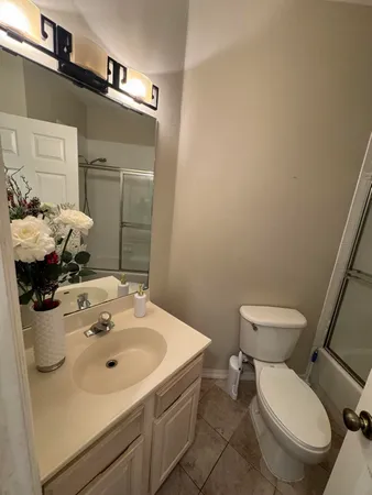 a bathroom with a sink toilet and a mirror