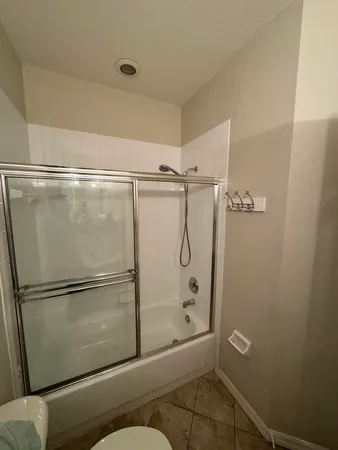 a bathroom with a glass shower door