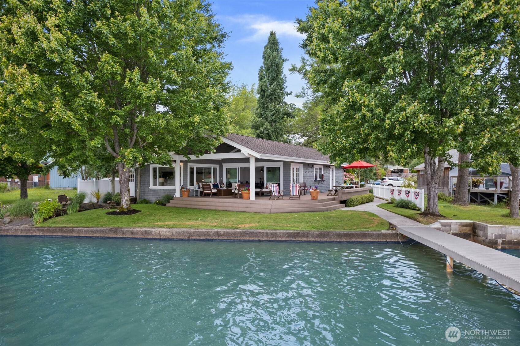 a front view of a house with a yard table and chairs
