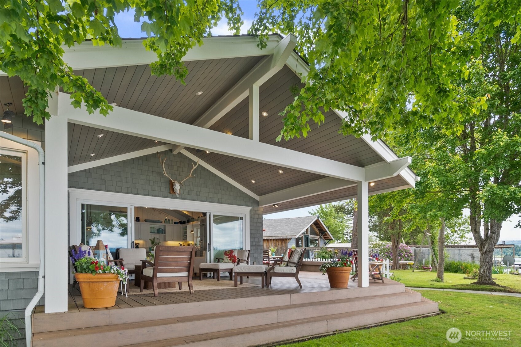 412 Streeter Road Silverlake, WA 98645 - Photo 36 of 40 a view of a patio with table and chairs potted plants and a large tree