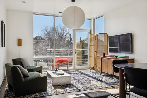 a living room with furniture a rug and a fireplace