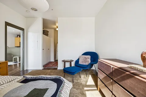 a bedroom with bed and a mirror