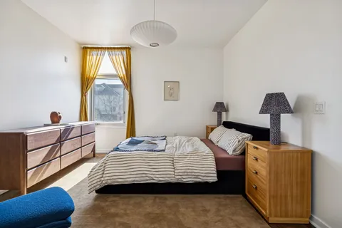 a bedroom with a bed and a chandelier