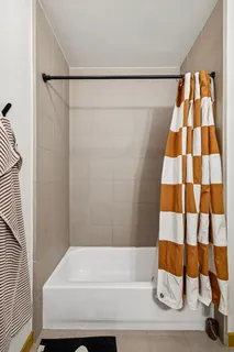 a bathroom with a bathtub and a shower