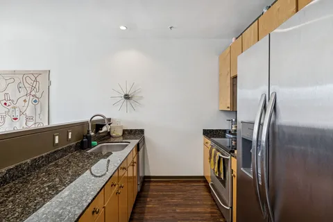 a kitchen with a sink appliances and cabinets