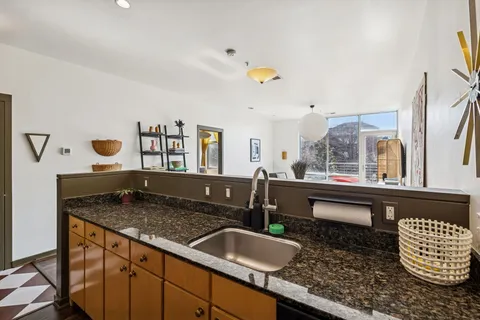 a bathroom with a granite countertop sink and a mirror