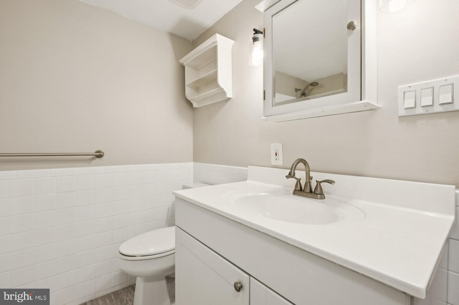 520 North Lemon Street, Unit E8 Media, PA 19063 - Photo 12 of 17 a bathroom with a sink a toilet and mirror