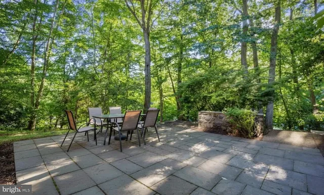 a view of a patio with table and chairs and potted plants