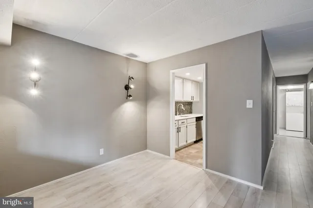 a view of a kitchen with wooden floor and a kitchen