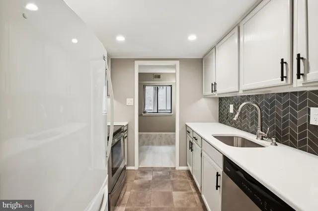 a kitchen with a sink and a refrigerator