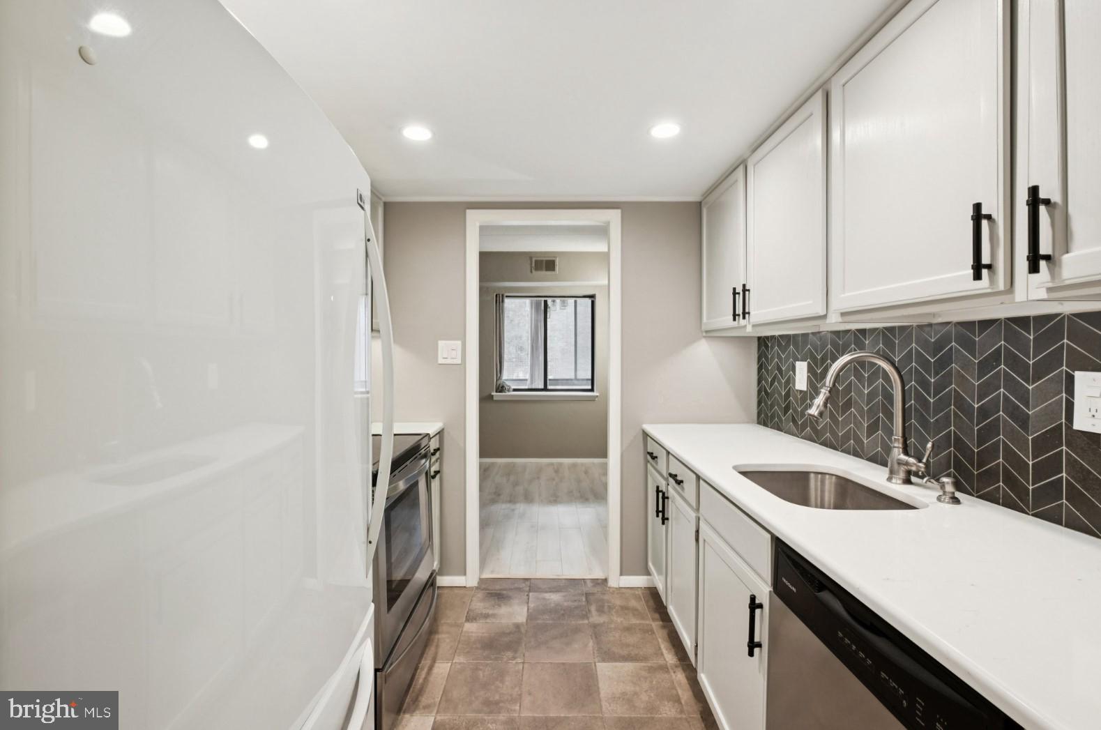520 North Lemon Street, Unit E8 Media, PA 19063 - Photo 5 of 17 a kitchen with a sink and a refrigerator