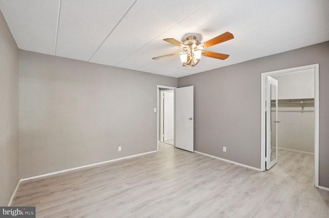 an empty room with a chandelier fan